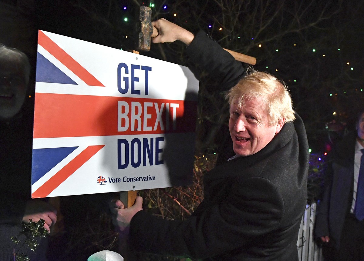 FILE -- In this Wednesday, Dec. 11, 2019 file photo, Britain's Prime Minister and Conservative party leader Boris Johnson poses as he hammers a "Get Brexit Done" sign into the garden of ...