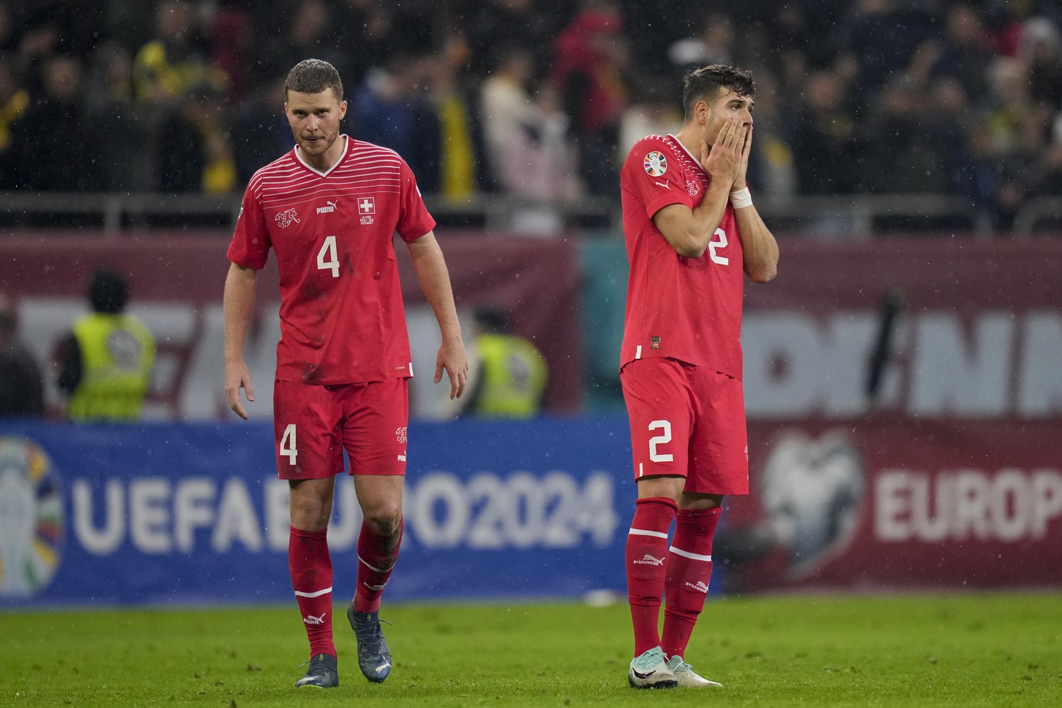 Switzerland&#039;s Filip Ugrinic, right, and Switzerland&#039;s Nico Elvedi are dejected after the Euro 2024, group I, qualifying soccer match between Romania and Switzerland at the National Arena sta ...