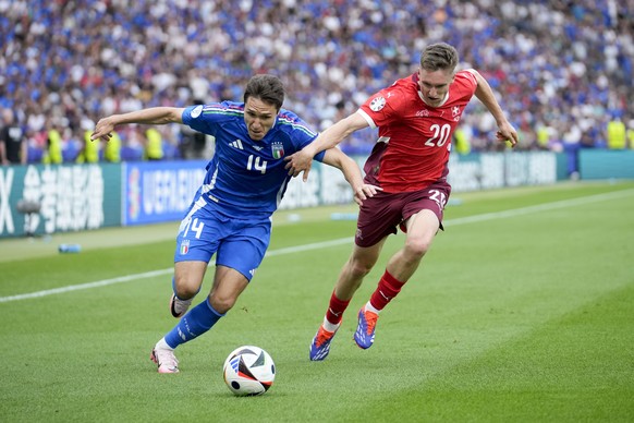 Italy&#039;s Federico Chiesa, left, is defended by Switzerland&#039;s Michel Aebischer during a round of sixteen match between Switzerland and Italy at the Euro 2024 soccer tournament in Berlin, Germa ...