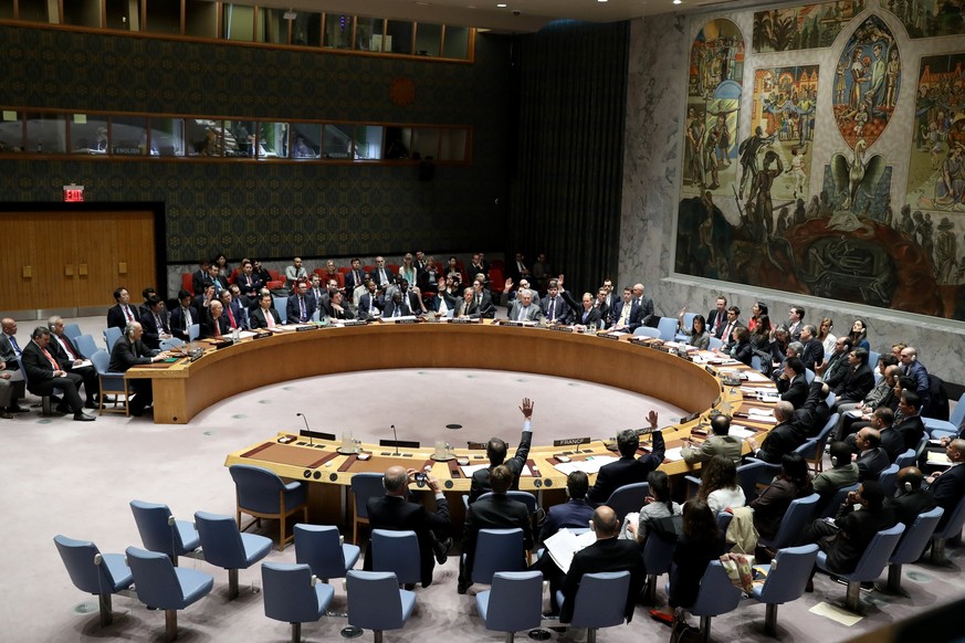 epa05905029 Members of the United Nations Security Council (UNSC) vote on a draft resolution condemning the Syrian government use of chemical weapons during a Security Council meeting at United Nation ...