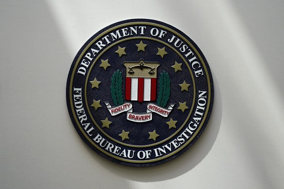FILE - The FBI seal is pictured in Omaha, Neb., Aug. 10, 2022. A man who federal agents say tried to board a plane in New Jersey with three guns, including a semi-automatic rifle, and a fake law-enfor ...