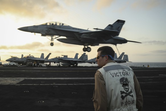 epa07632525 A handout photo made available by the US Navy shows US Lt. Nicholas Yerkes, from Annapolis, Maryland, a landing signals officer aboard the Nimitz-class aircraft carrier USS Abraham Lincoln ...