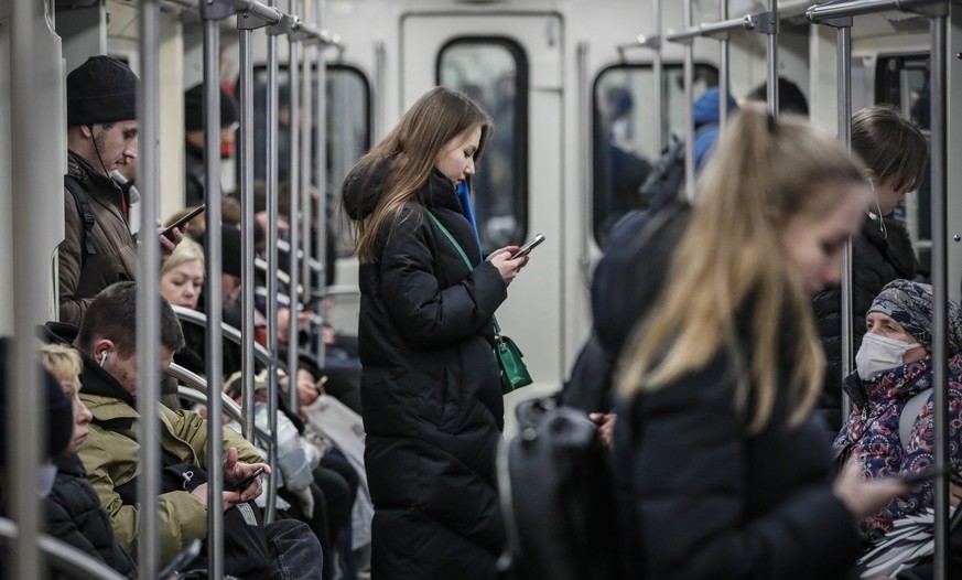 epa09826478 Maskless people at the Metro in Moscow, Russia, 15 march 2022, the mayor of Moscow, Sergei Sobyanin, has cancelled the obligation to wear masks in public places starting from 15 March. EPA ...