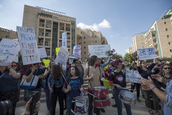 epa06736271 Israeli activists and Palestinians hold banners during a protest outside of the US embassy in Jerusalem, during the official inauguration ceremony, 14 May 2018. The US Embassy in Jerusalem ...