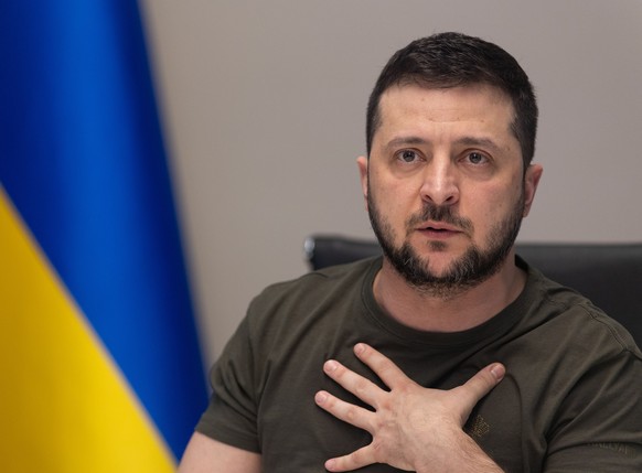 epa09855228 A handout photo made available by the Ukrainian Presidential Press Service shows Ukrainian President Volodymyr Zelensky reacting during an interview via videolink with Russian media, in Ky ...