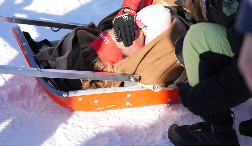 epa09761336 Irene Cadurish of Switzerland receives medical attention during the Women&#039;s Biathlon 4x6km Relay race at the Zhangjiakou National Biathlon Centre at the Beijing 2022 Olympic Games, Zh ...