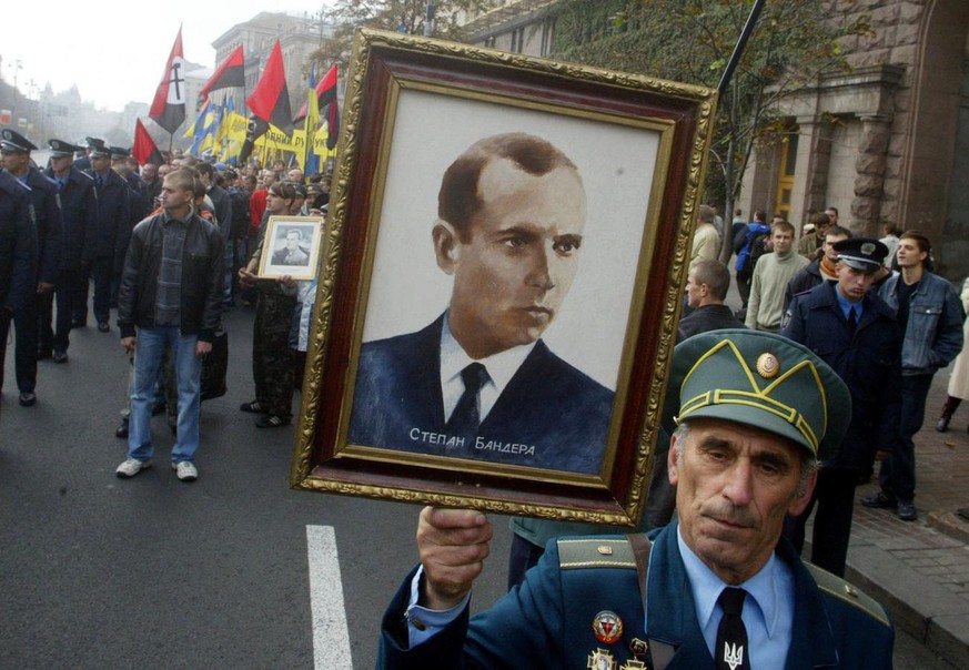 In this Oct. 15, 2005 file photo, a partisan veteran from the Ukrainian Insurgent Army carries a portrait of Ukrainian Insurgent Army leader Stepan Bandera during a march in Kiev. Ukraine. The office  ...