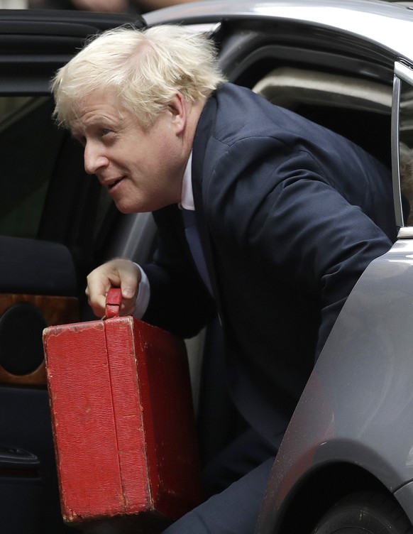 British Prime Minister Boris Johnson, center, arrives at Downing Street in London, Wednesday, Sept. 25, 2019. Lawmakers in Britain are returning to the House of Commons on Wednesday, following a Supre ...