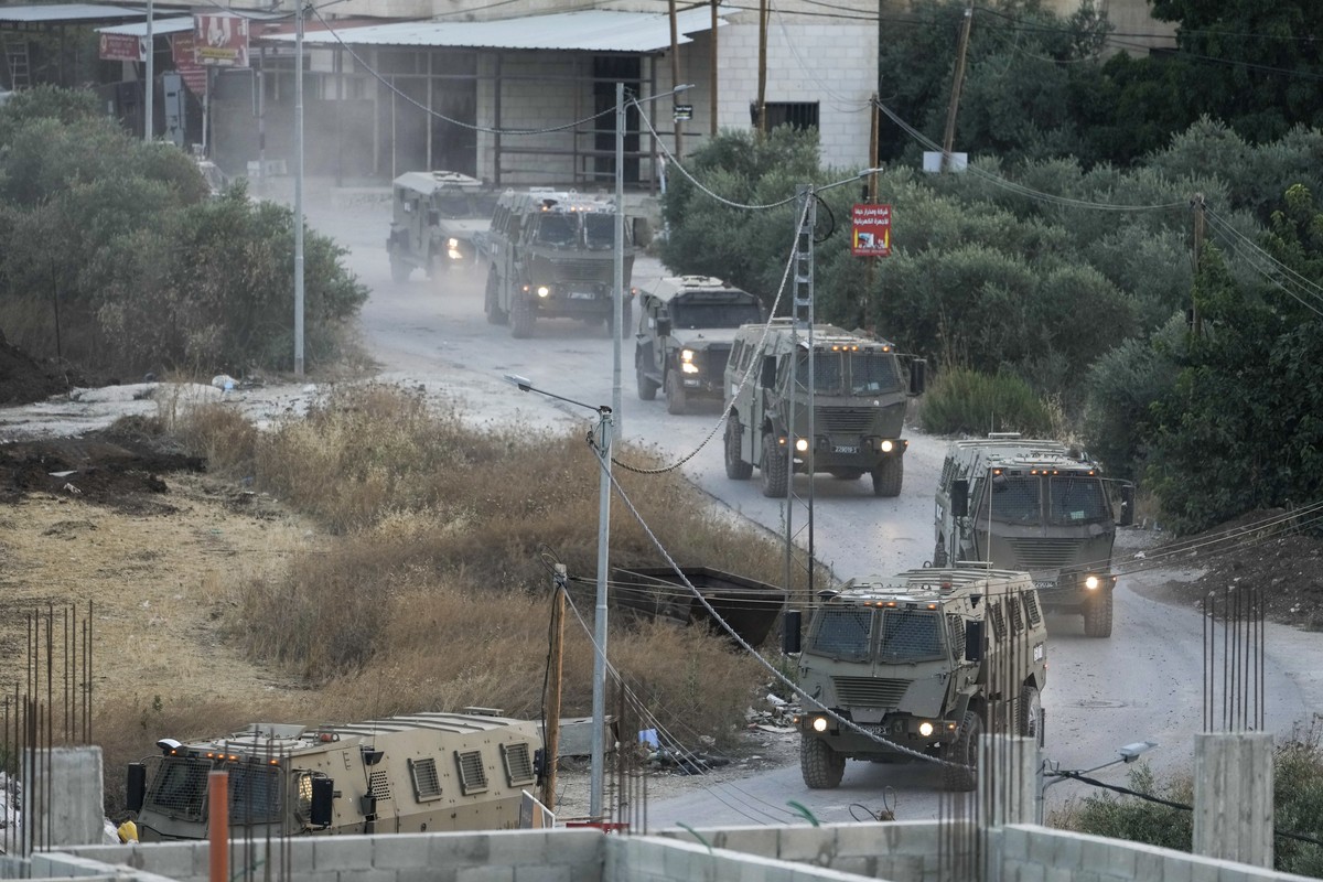 A convoy of army vehicles is seen during a military raid in the Jenin refugee camp, a militant stronghold, in the occupied West Bank, Tuesday, July 4, 2023. Palestinian health officials said at least  ...