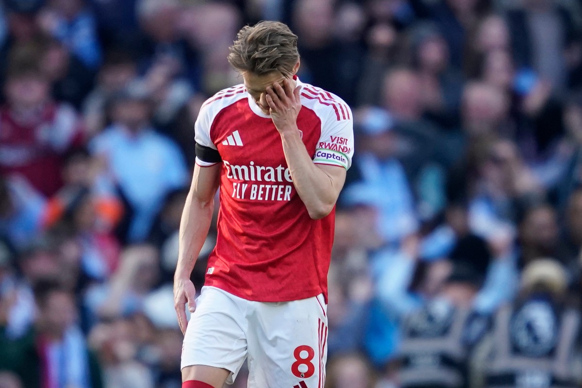 Arsenal's Martin Odegaard reacts after Manchester City's Erling Haaland scored his side's second goal during the English Premier League soccer match between Manchester City and and Arse ...
