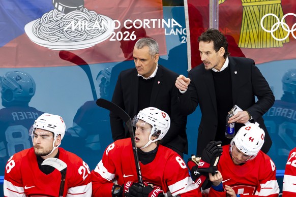 Patrick Fischer, right, head coach of Switzerland national ice hockey team, gestures next to Jan Cadieux, left, assistant coach of Switzerland national ice hockey team, during the men's group A p ...