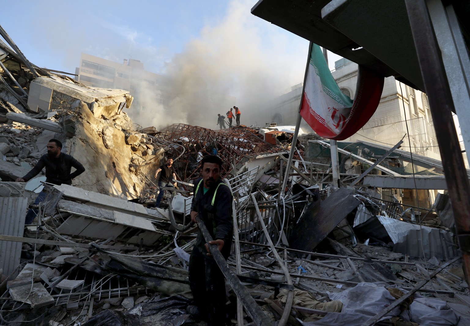 Emergency services work at a building hit by an air strike in Damascus, Syria, Monday, April 1, 2024. An Israeli airstrike that demolished Iran?s consulate in Damascus Monday killed two Iranian genera ...