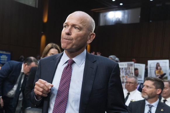 With protesters in the audience, Boeing CEO Dave Calhoun takes his seat to testify before the Senate Homeland Security and Governmental Affairs Subcommittee on Investigations to answer to lawmakers ab ...