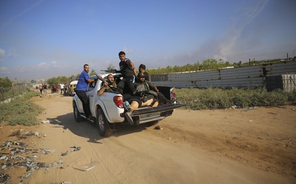 CORRECTS IDENTITY OF THE BODY IN THE TRUCK TO SHANI LOUK, NOT AN ISRAELI SOLDIER - Palestinian militants drive back to the Gaza Strip with the body of Shani Louk, a German-Israeli dual citizen, on Sat ...
