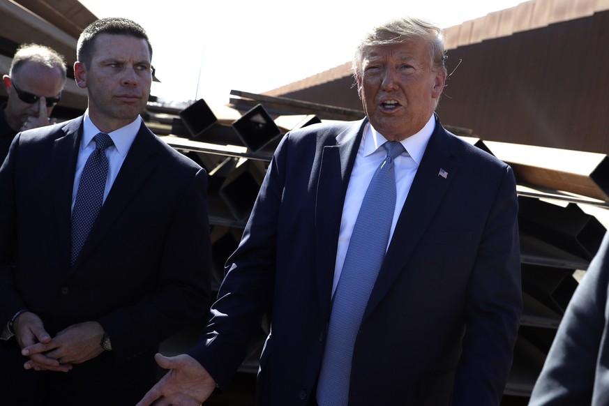 FILE - In this Sept. 18, 2019, file photo, President Donald Trump talks with reporters as he tours a section of the southern border wall, in Otay Mesa, Calif., as acting Homeland Secretary Kevin McAle ...