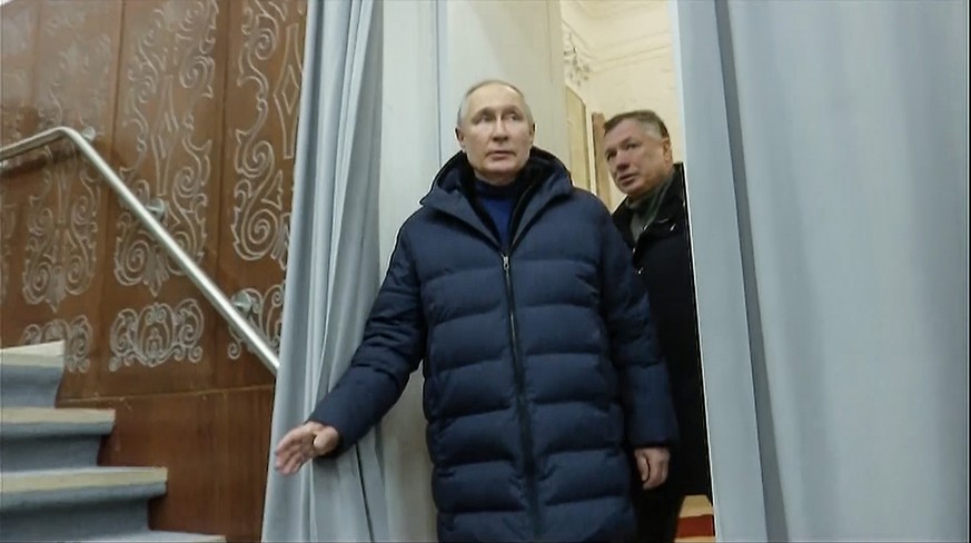 In this photo taken from video released by Russian TV Pool on Sunday, March 19, 2023, Russian President Vladimir Putin escorting by Russian Deputy Prime Minister Marat Khusnullin visits the Mariupol t ...