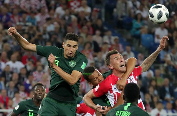 epa06814442 William Ekong (C) of Nigeria fouls Mario Mandzukic (R) of Croatia in the penalty box during the FIFA World Cup 2018 group D preliminary round soccer match between Croatia and Nigeria in Ka ...