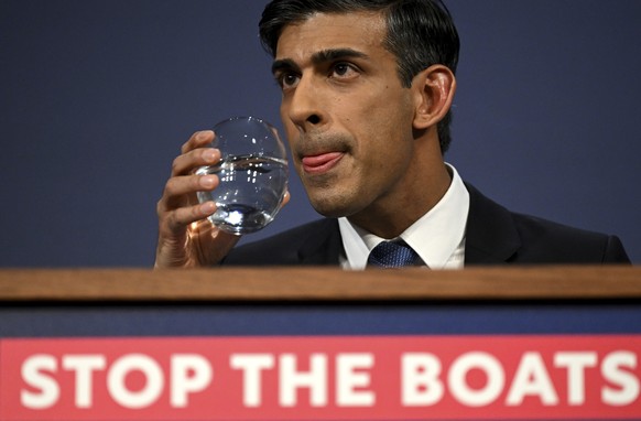 FILE - Britain&#039;s Prime Minister Rishi Sunak prepares to take a sip of water during a press conference following the launch of new legislation on migrant channel crossings at Downing Street, Londo ...