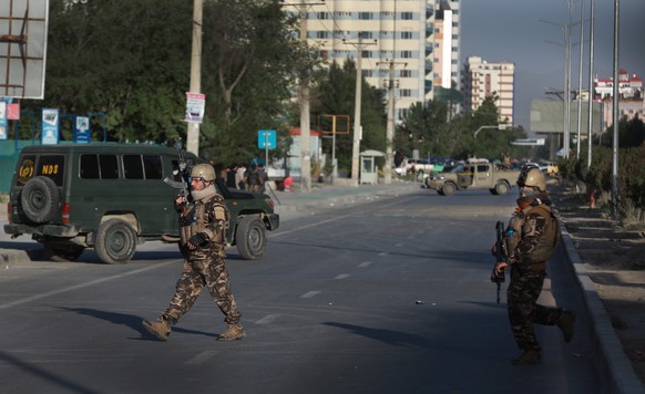 epa08454238 Afghan security officers stand guard after an explosion in downtown Kabul, Afghanistan, 30 May 2020. According to the police officials, two people were killed, including a local TV reporte ...