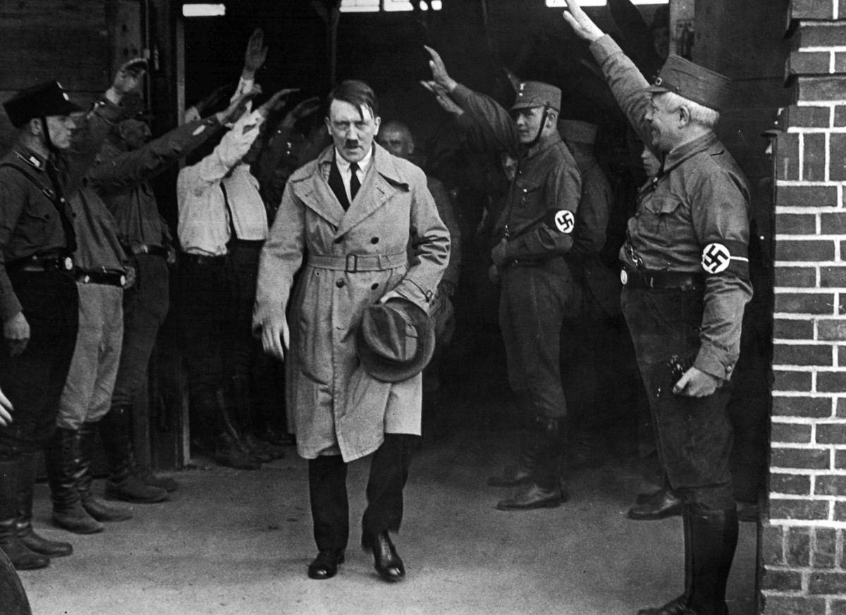 FILE - In this Dec. 5, 1931 file photo, Adolf Hitler, leader of the National Socialists, is saluted as he leaves the party's Munich headquarters. The book, "Human Rights After Hitler" b ...