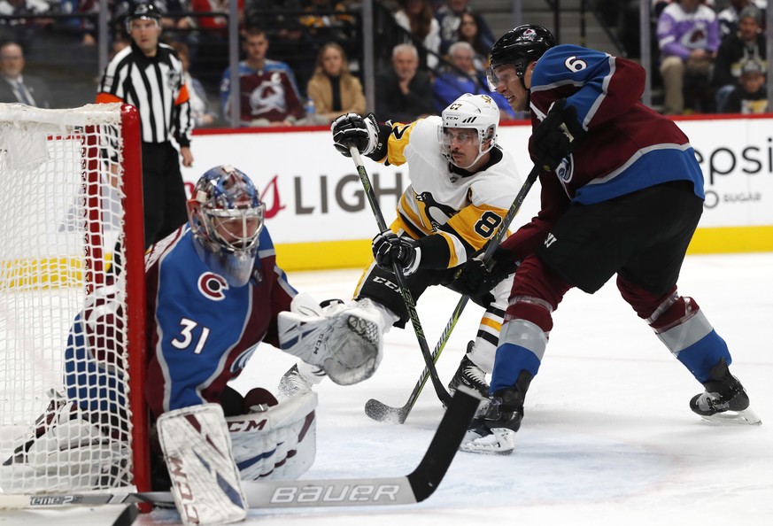 Pittsburgh Penguins center Sidney Crosby, center, follows his shot as the puck goes by Colorado Avalanche goaltender Philipp Grubauer, left, while Colorado Defenseman Erik Johnson looks on in the seco ...
