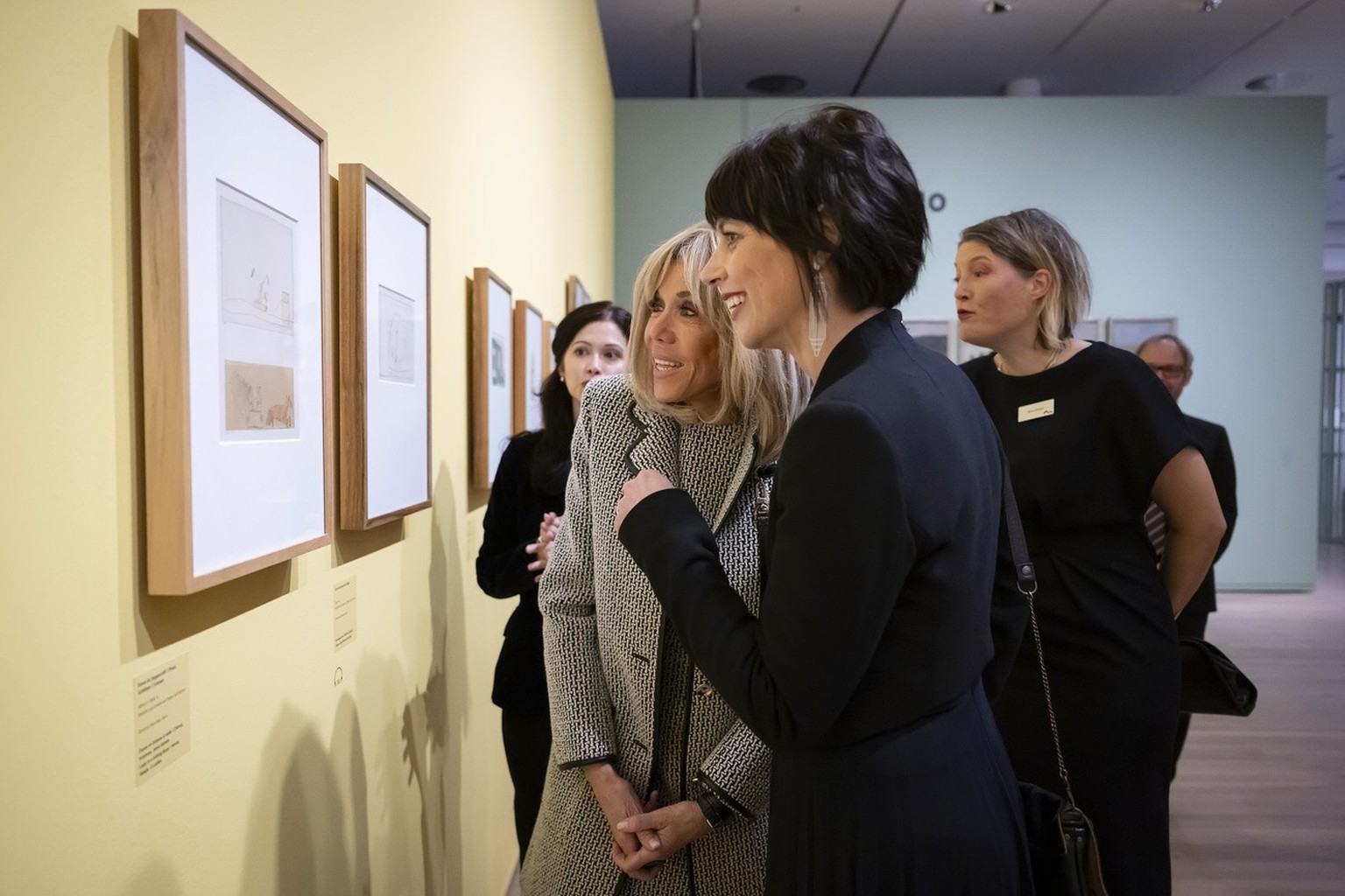 French First Lady Brigitte Macron, second from left, and Swiss First Lady Muriel Zeender Berset, second from right, view a painting by German artist Paul Klee, next to Nina Zimmer, immediately...