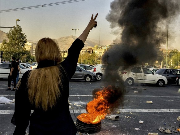 FILE - In this photo taken by an individual not employed by the Associated Press and obtained by the AP outside Iran, Iranians protests the death of 22-year-old Mahsa Amini after she was detained by t ...