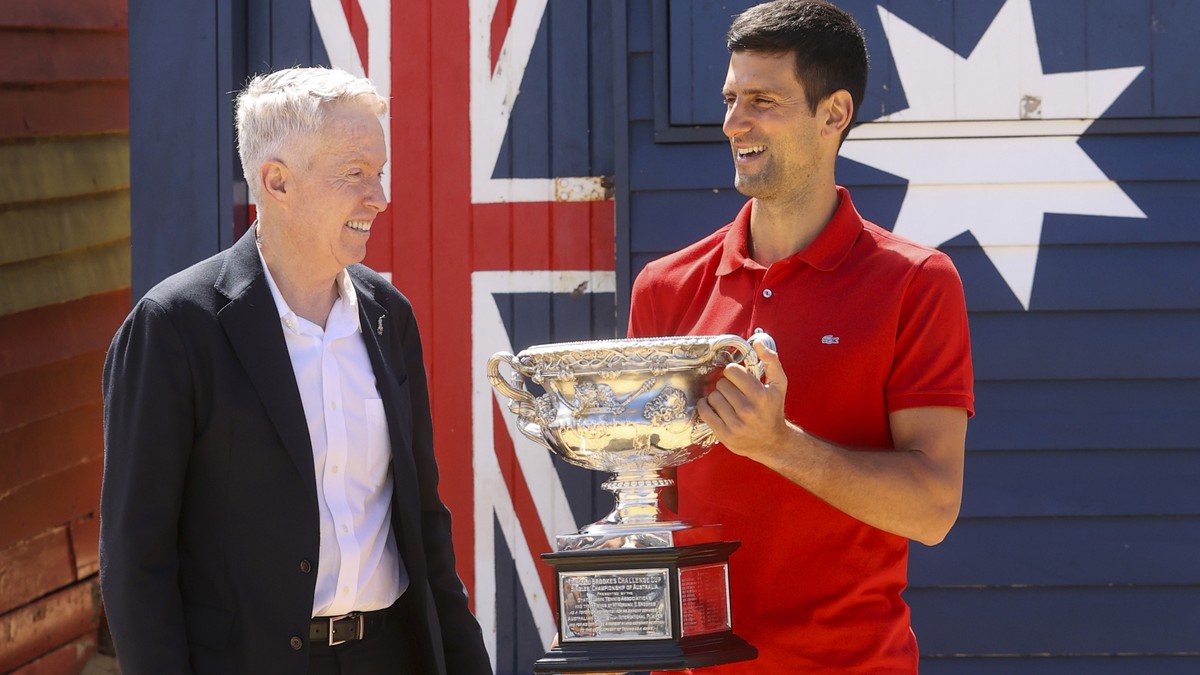 Serbia's Novak Djokovic, right, stands with Australian Open tournament director Craig Tiley for a trophy photo shoot following his win the Australian Open tennis championships in Melbourne, Austr ...
