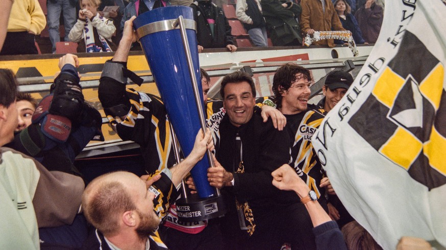 Jim Koleff, Eishockeytrainer beim HC Lugano, feiert mit Pokal, Fans und seinen Spielern den Sieg in der Schweizermeisterschaft, aufgenommen 5. April 1999 in Lugano. (KEYSTONE/Karl Mathis)