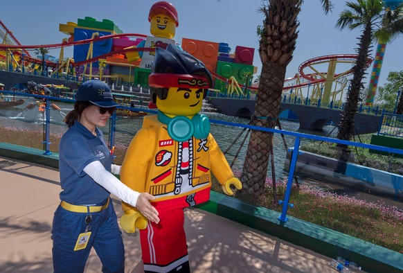 A worker guides a Lego mascot character during the opening of Legoland Shanghai, China&#039;s first Legoland resort, in Shanghai, Saturday, July 5, 2025. (AP Photo/Ng Han Guan)
China Legoland