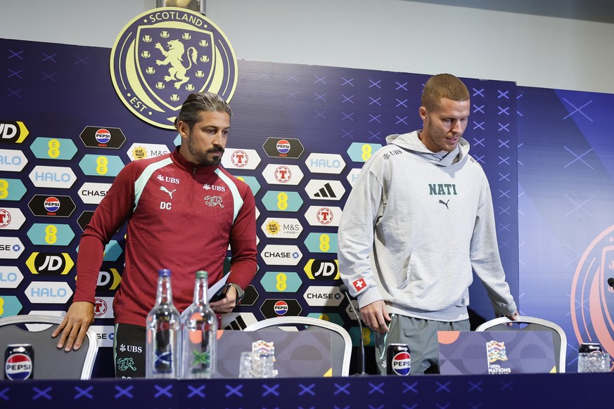 epa13269162 Switzerland's assistant coach Davice Calla (L) and player Nico Elvedi attend a press conference one day ahead of the UEFA Nations League soccer match between Scotland and Switzerland  ...