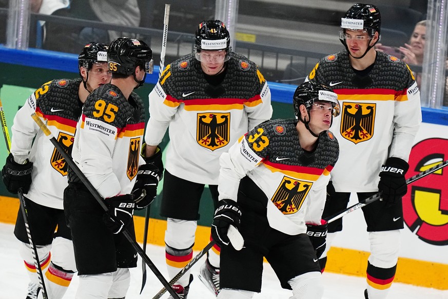 Germany&#039;s John Peterka, second from right, celebrates with teammates after scoring his side&#039;s fifth goal during the group A match between Germany and Hungary at the ice hockey world champion ...