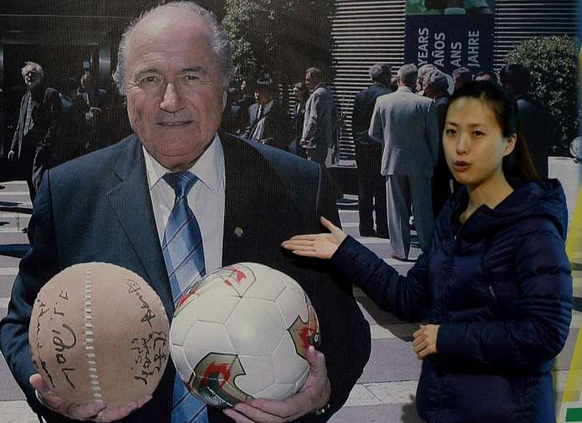 Blatter im Museum in Linzi, links ein Cuju-Ball in der Hand.