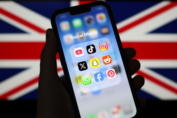 epa12674761 Social Media applications displayed on a mobile phone alongside a Union Flag displayed on a laptop screen in Liverpool, Britain, 23 January 2026. A proposal to ban under-16s from accessing ...