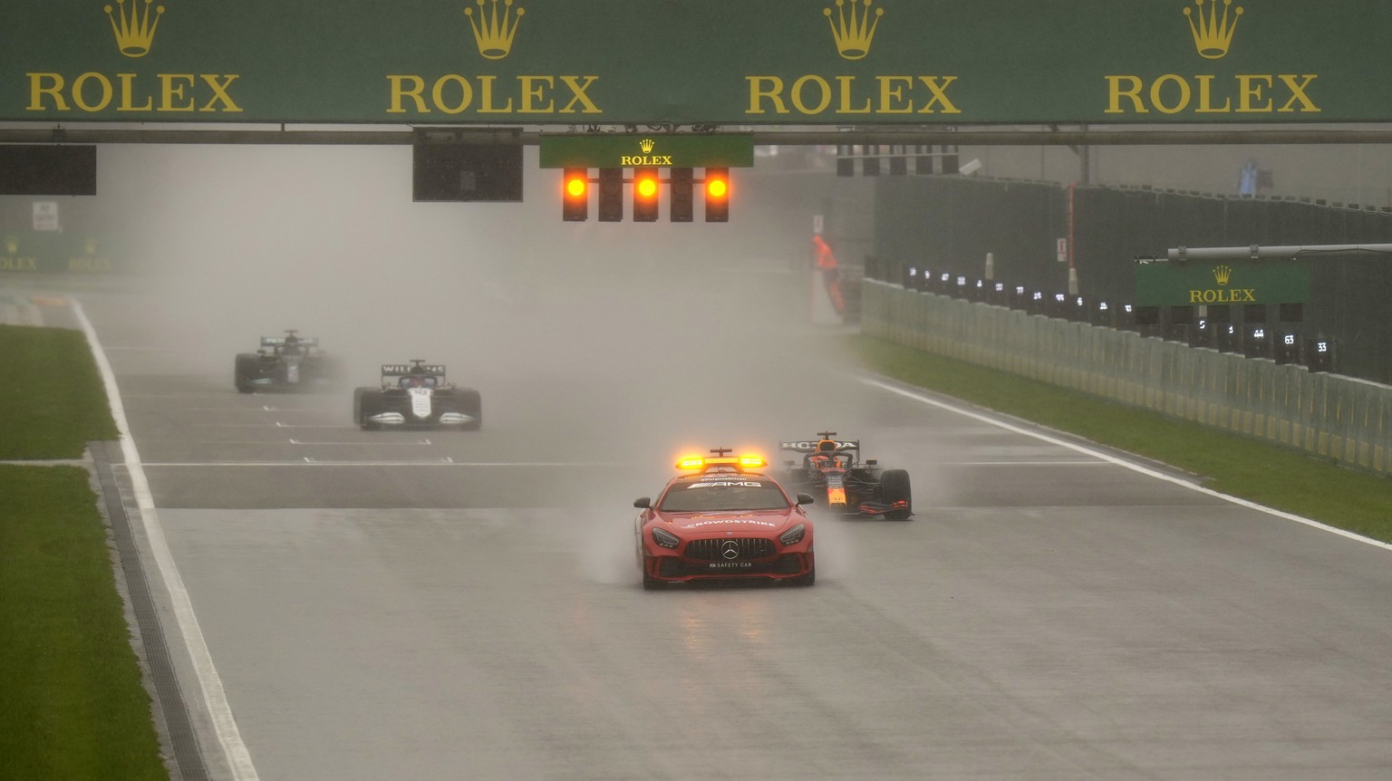 Drivers steer their cars behind the safety car during the Formula One Grand Prix at the Spa-Francorchamps racetrack in Spa, Belgium, Sunday, Aug. 29, 2021. (AP Photo/Francisco Seco)