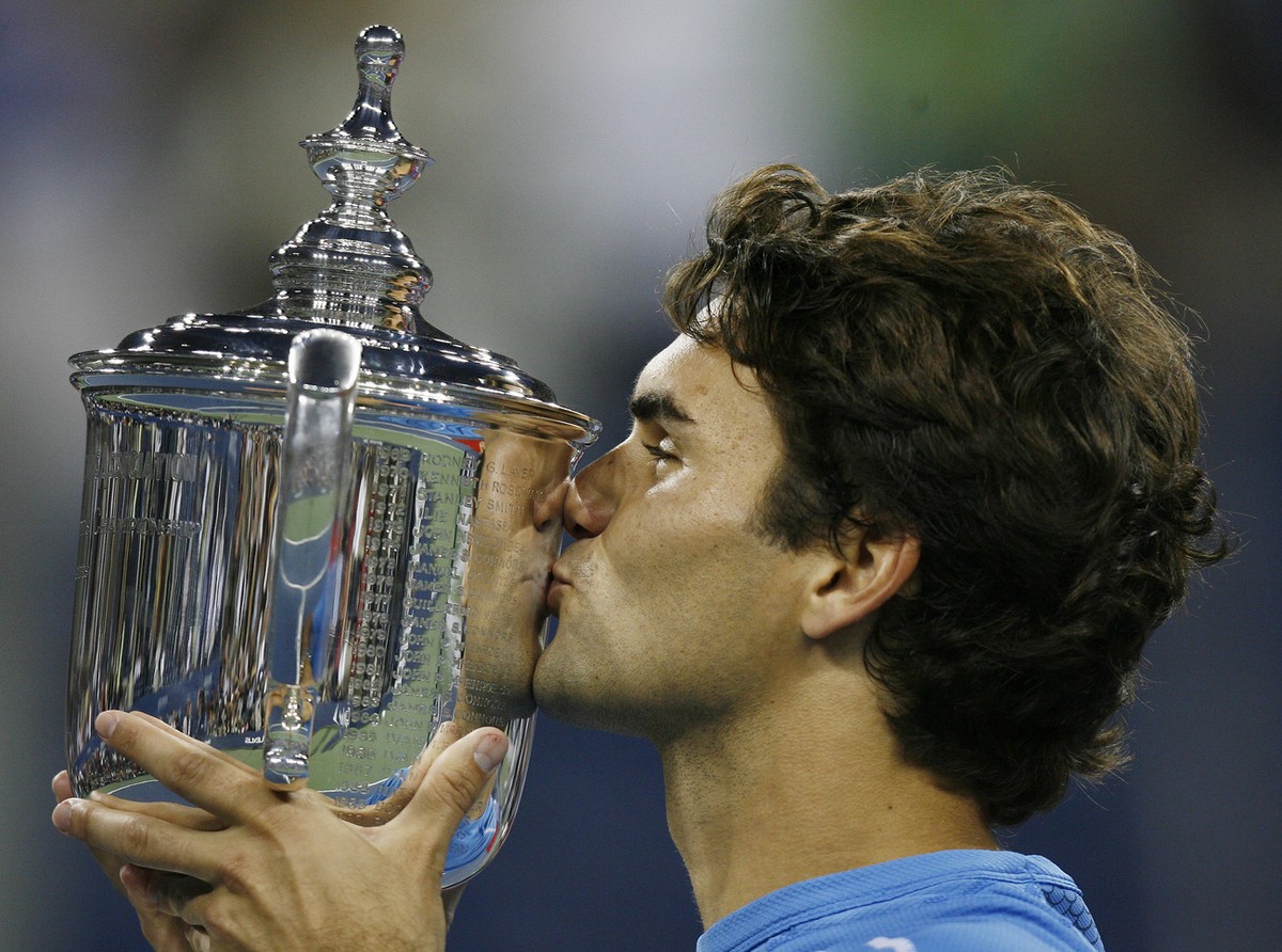 Roger Federer, of Switzerland, kisses the men's singles championship trophy after defeating Andy Roddick, of the United States, at the US Open tennis tournament in New York, Sunday, Sept. 10, 200 ...