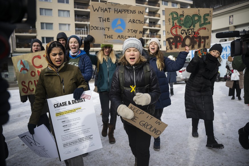 Climate activist Greta Thunberg of Sweden, center, attends with others a &quot;Friday for Future Climate Strike&quot; demonstration on the sideline of the final day of the 53rd annual meeting of the W ...