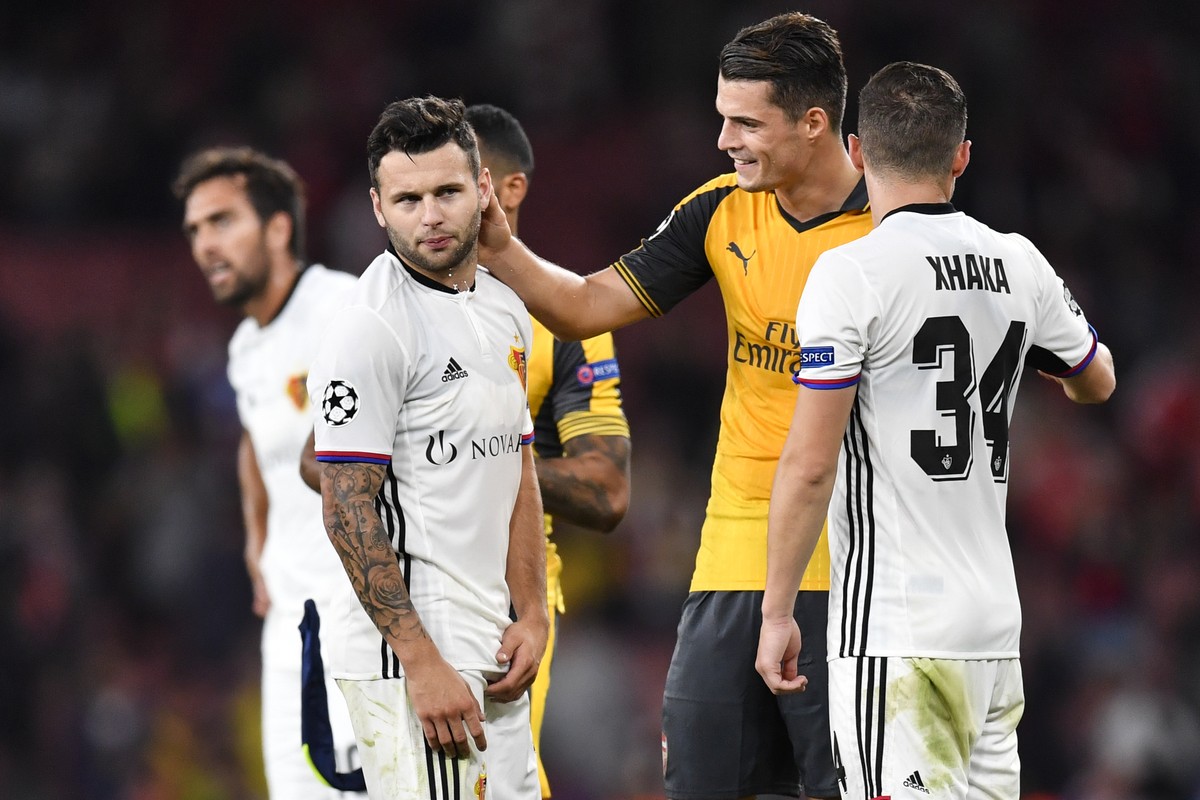Basel's Renato Steffen, left, and Taulant Xhaka, talk to Arsenals Granit Xhaka, after an UEFA Champions League Group stage Group A matchday 2 soccer match between England's Arsenal FC and Sw ...