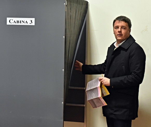 epa06578405 Matteo Renzi of the Democratic Party enters a voting booth prior to casting his vote for the general elections at a polling station in Florence, Italy, 04 March 2018. General elections are ...