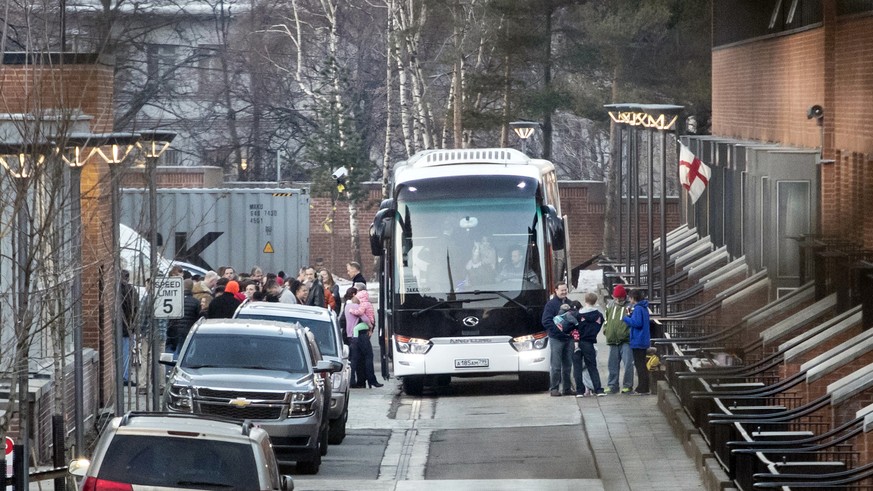 Buses wait to carry expelled diplomats and their families to leave the U.S. Embassy in Moscow, Russia, Thursday, April 5, 2018. Russia last week ordered 60 American diplomats to leave the country by T ...