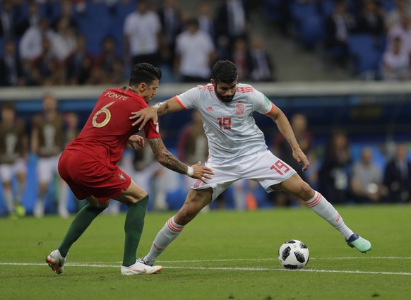 Spain&#039;s Diego Costa, competes the ball with Portugal&#039;s Jose Fonte during the group B match between Portugal and Spain at the 2018 soccer World Cup in the Fisht Stadium in Sochi, Russia, Frid ...