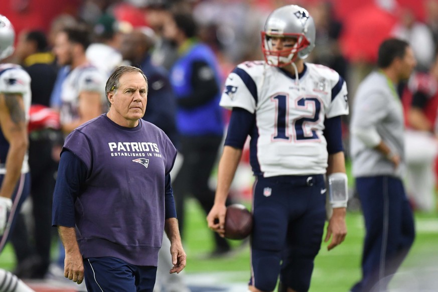 Feb 5, 2017; Houston, TX, USA; New England Patriots head coach Bill Belichick walks the field during warm-ups as quarterback Tom Brady (12) stands in the background before Super Bowl LI against the At ...