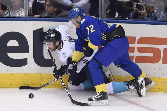 Team Europe&#039;s Mark Streit (7) and Team Sweden&#039;s Patric Hornqvist (72) battle for the puck during first-period World Cup of Hockey semifinal action in Toronto, Sunday, Sept. 25, 2016. (Nathan ...