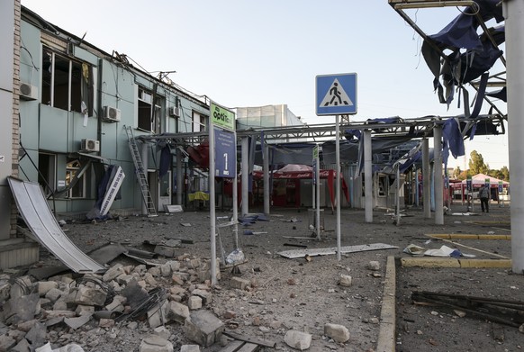 epa12292775 Ukrainian rescuers and policemen work at the site of the Russian strike on a bus station in Zaporizhzhia, Ukraine, 10 August 2025. At least 19 people were injured after a Russian guided ae ...