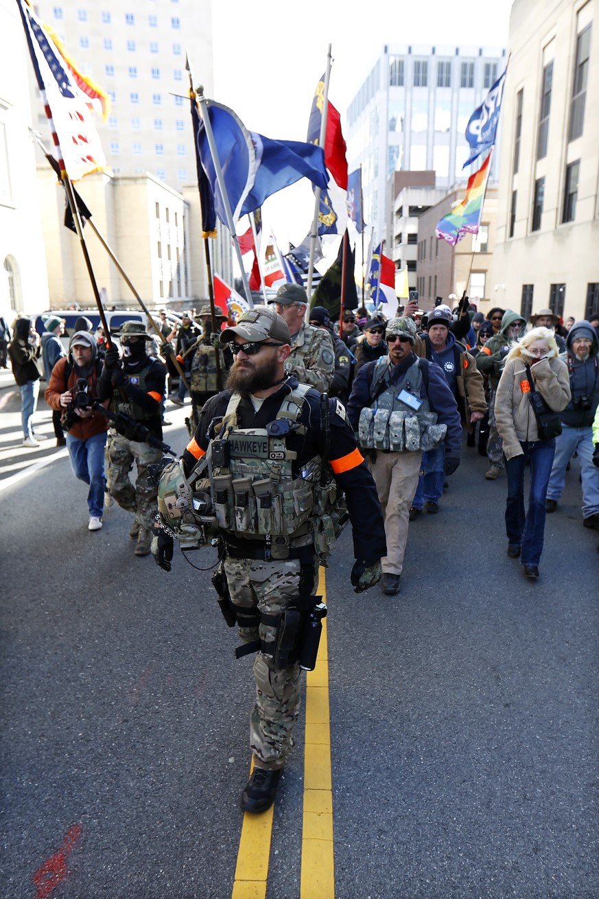 Demonstrators march during a pro-gun rally, Monday, Jan. 20, 2020, in Richmond, Va. Thousands of pro-gun supporters are expected at the rally to oppose gun control legislation like universal backgroun ...