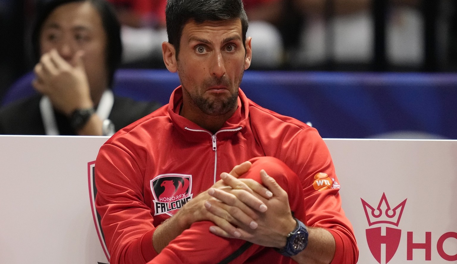 From left to right, Aryna Sabalenka, Novak Djokovic , and former Moroccan tennis player, Younes El Aynaoui, from Falcons, watch a match during day three of the World Tennis League at Coca-Cola Arena,  ...