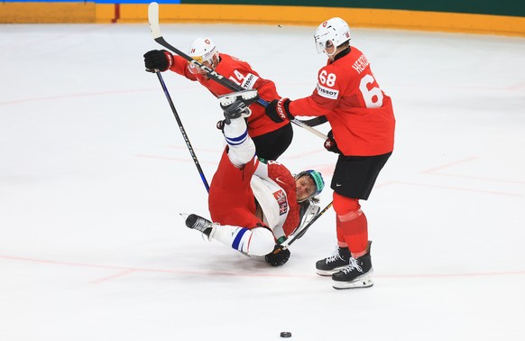 epa11372196 Czech Republic's Ondrej Beranek (C) in action against Switzerland's Dean Kukan (L) and Fabrice Herzog (R) during the gold medal match between Switzerland and Czech Republic at th ...