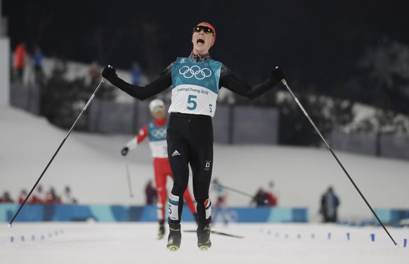 Eric Frenzel, of Germany, celebrates after winning the the gold medal after the 10km cross-country skiing portion of the nordic combined event at the 2018 Winter Olympics in Pyeongchang, South Korea,  ...