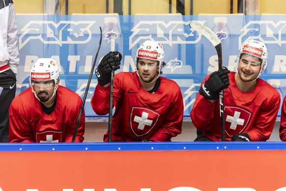 Switzerland's defender Jonas Siegenthaler, left, Switzerland's forward Nico Hischier, centre, and Switzerland's forward Timo Meier, right, Look their teammates, during a Switzerland tea ...