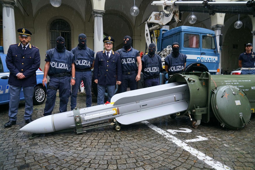 Police stand by a missile seized at an airport hangar near Pavia, northern Italy, following an investigation into Italians who took part in the Russian-backed insurgency in eastern Ukraine, in Turin,  ...